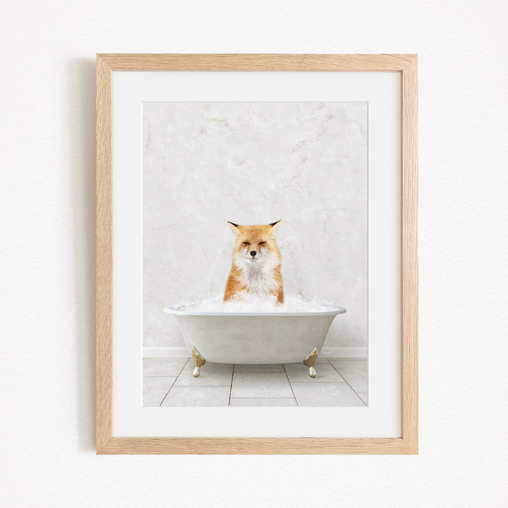 A framed image of a fox sitting in a bathtub filled with water.
