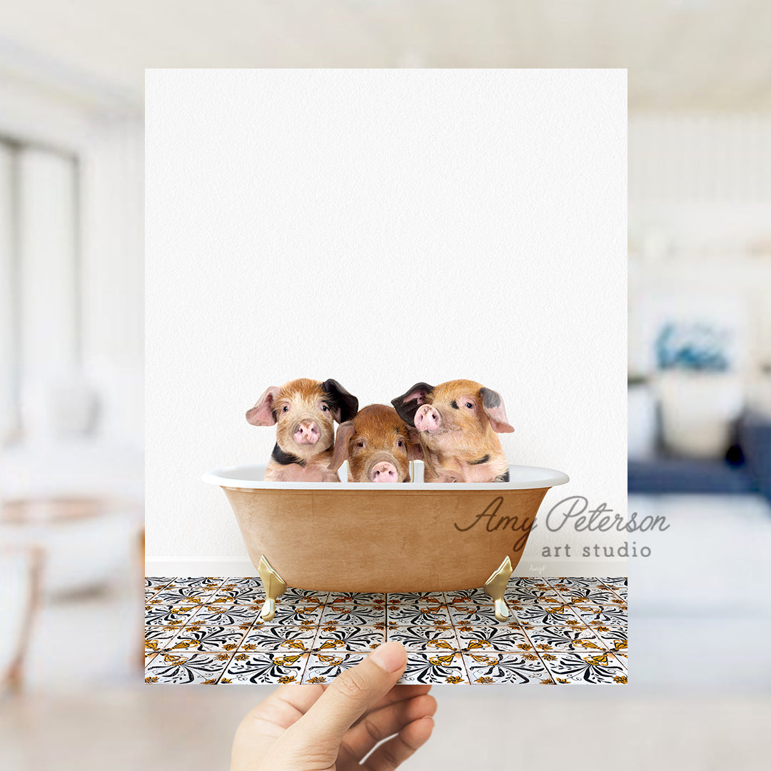 a hand holding a card with three miniature pigs in a bathtub