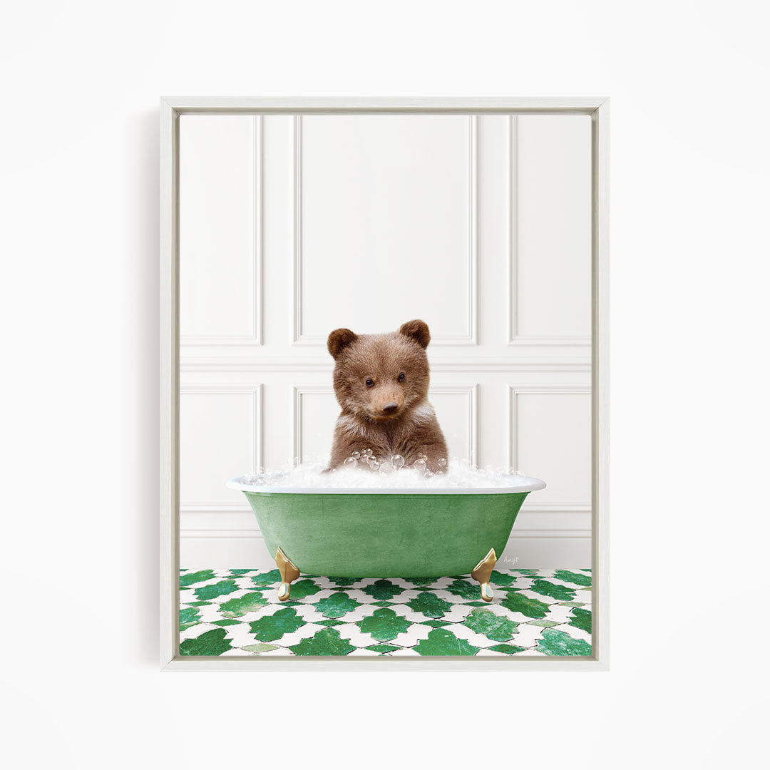 A cute brown bear sitting in a green bathtub filled with bubbles, surrounded by a green and white patterned floor.