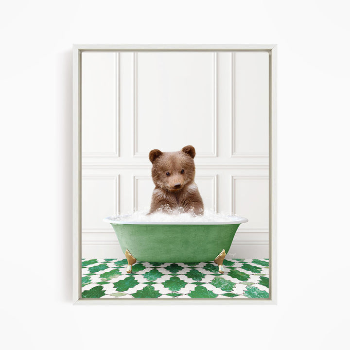 A cute brown bear sitting in a green bathtub filled with bubbles, surrounded by a green and white patterned floor.