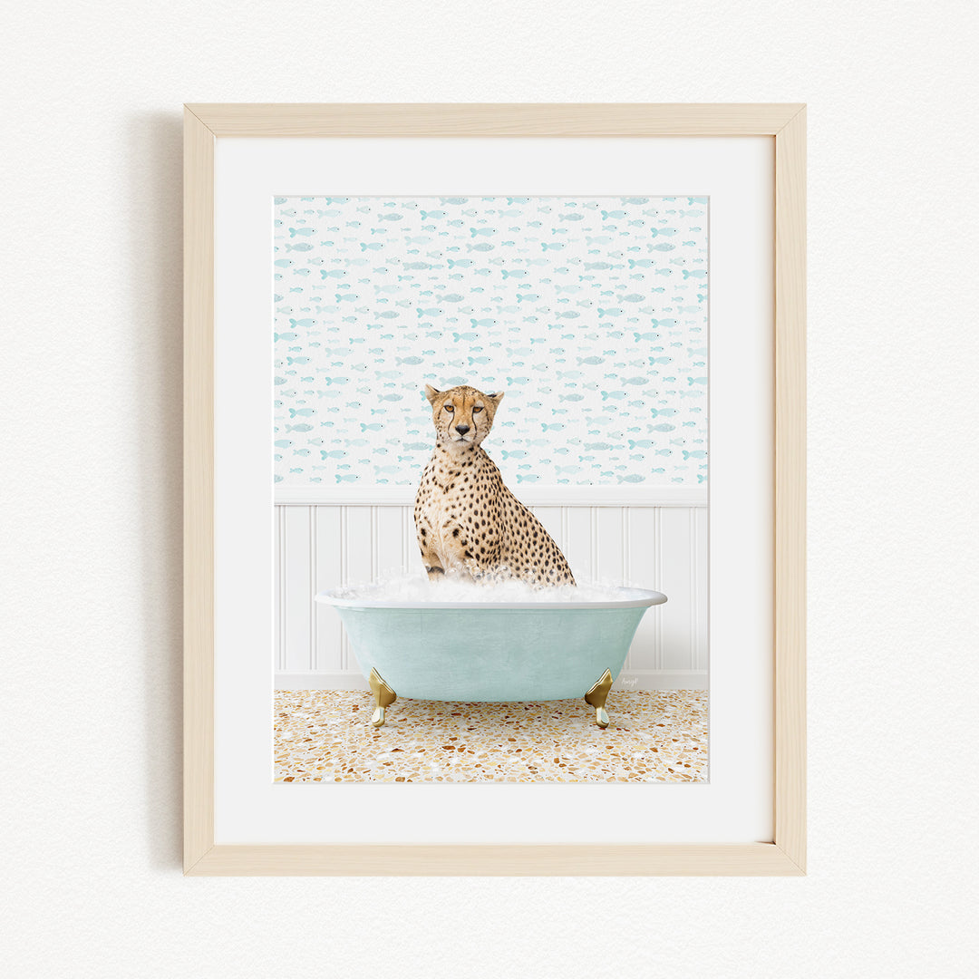 A cheetah sitting in a blue bathtub filled with water, surrounded by a patterned wall.