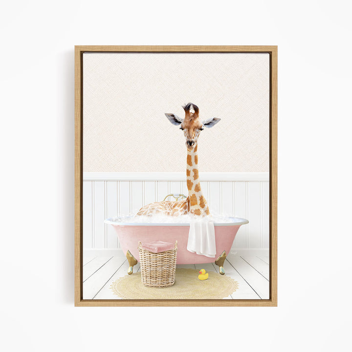 A giraffe is sitting in a pink bathtub filled with bubbles, surrounded by a yellow rubber duck and a wicker basket.
