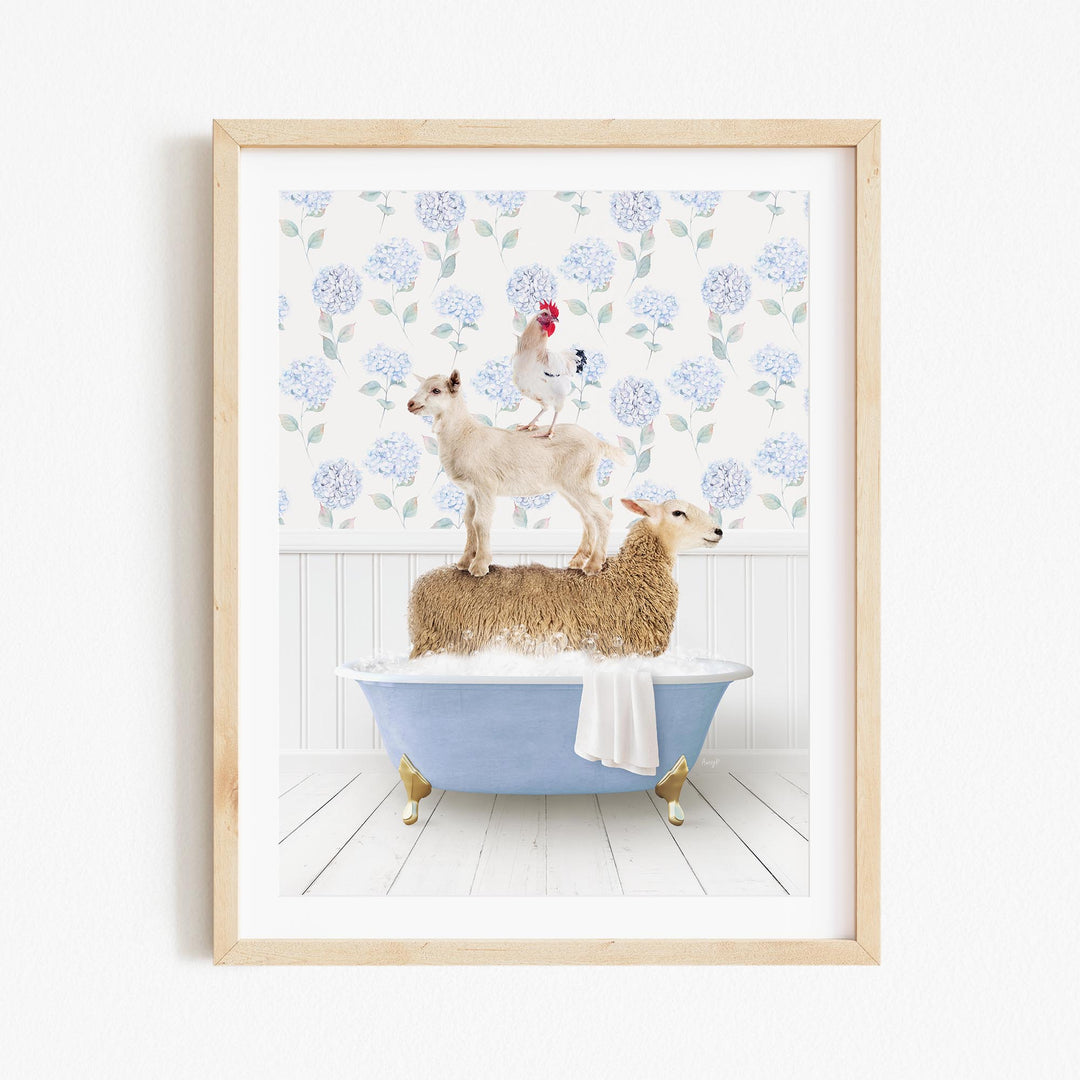 A framed image depicting a sheep standing on a tub filled with bubbles, with a chicken perched on top of the sheep and a rooster standing on the sheep's back.