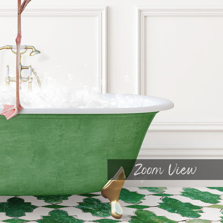 A green clawfoot bathtub filled with water, with a gold faucet and a pink towel hanging on the side.