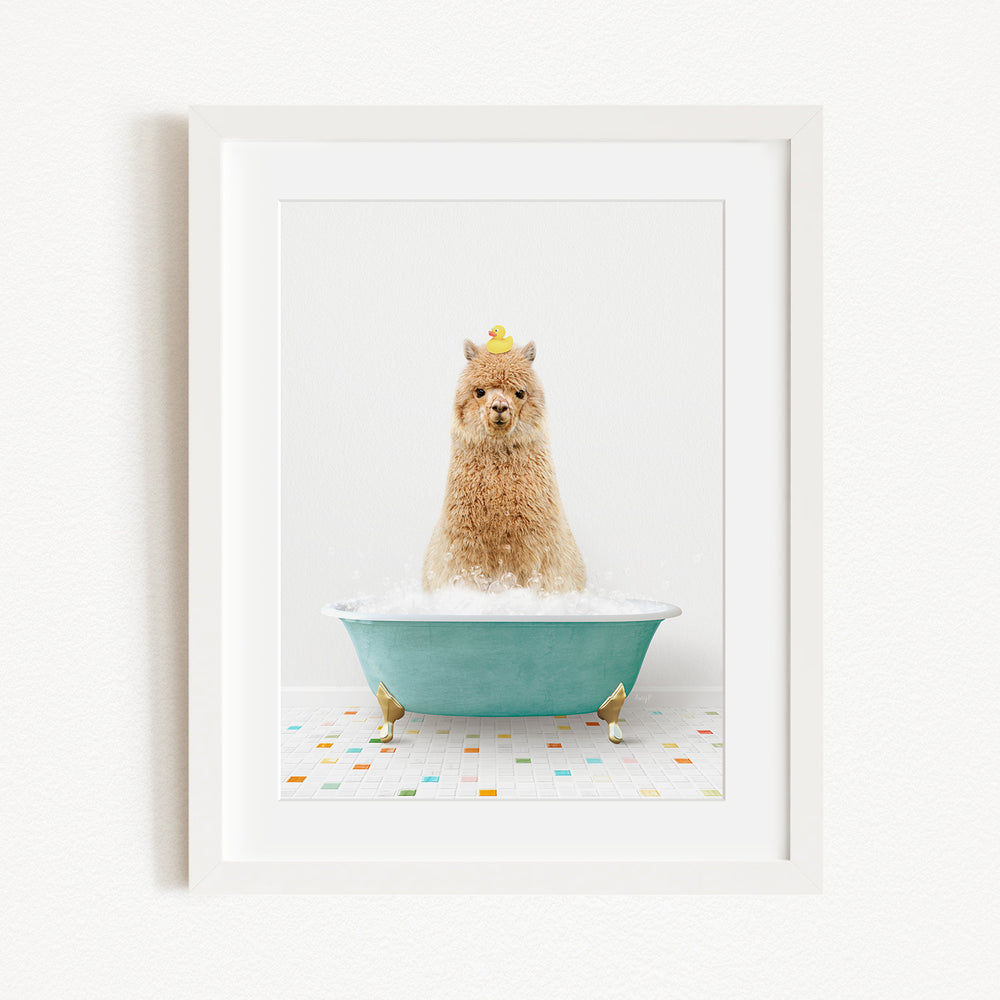 A fluffy alpaca sits in a blue bathtub filled with bubbles, wearing a yellow crown and surrounded by small rubber duckies.
