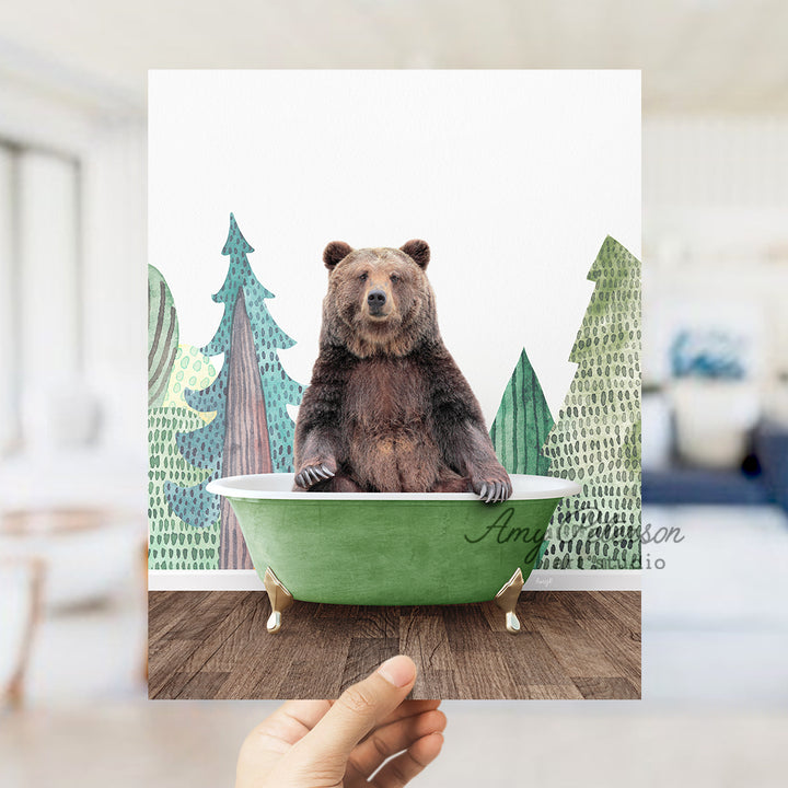 a person holding up a polaroid picture of a bear in a bathtub