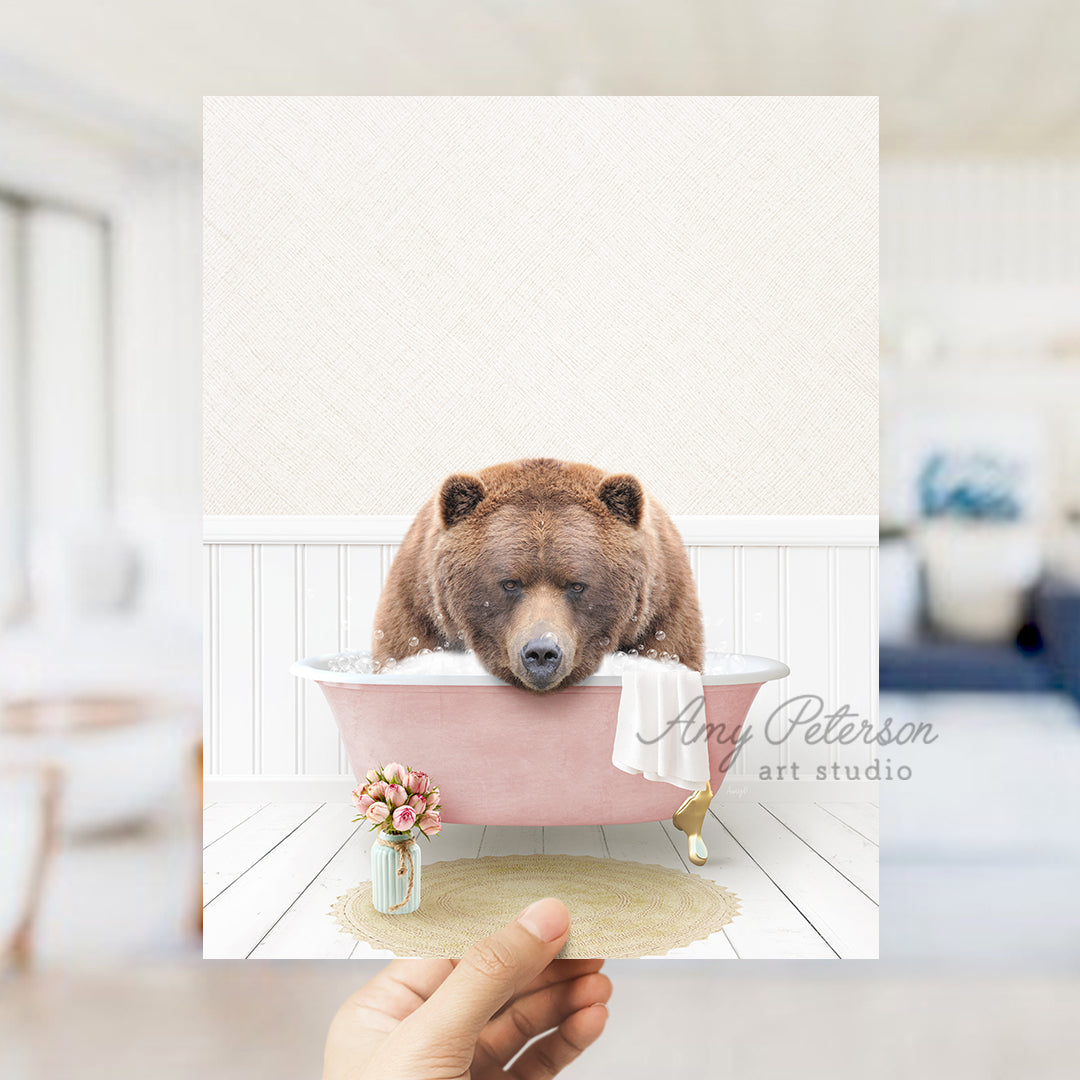 a person holding up a card with a bear in a bathtub