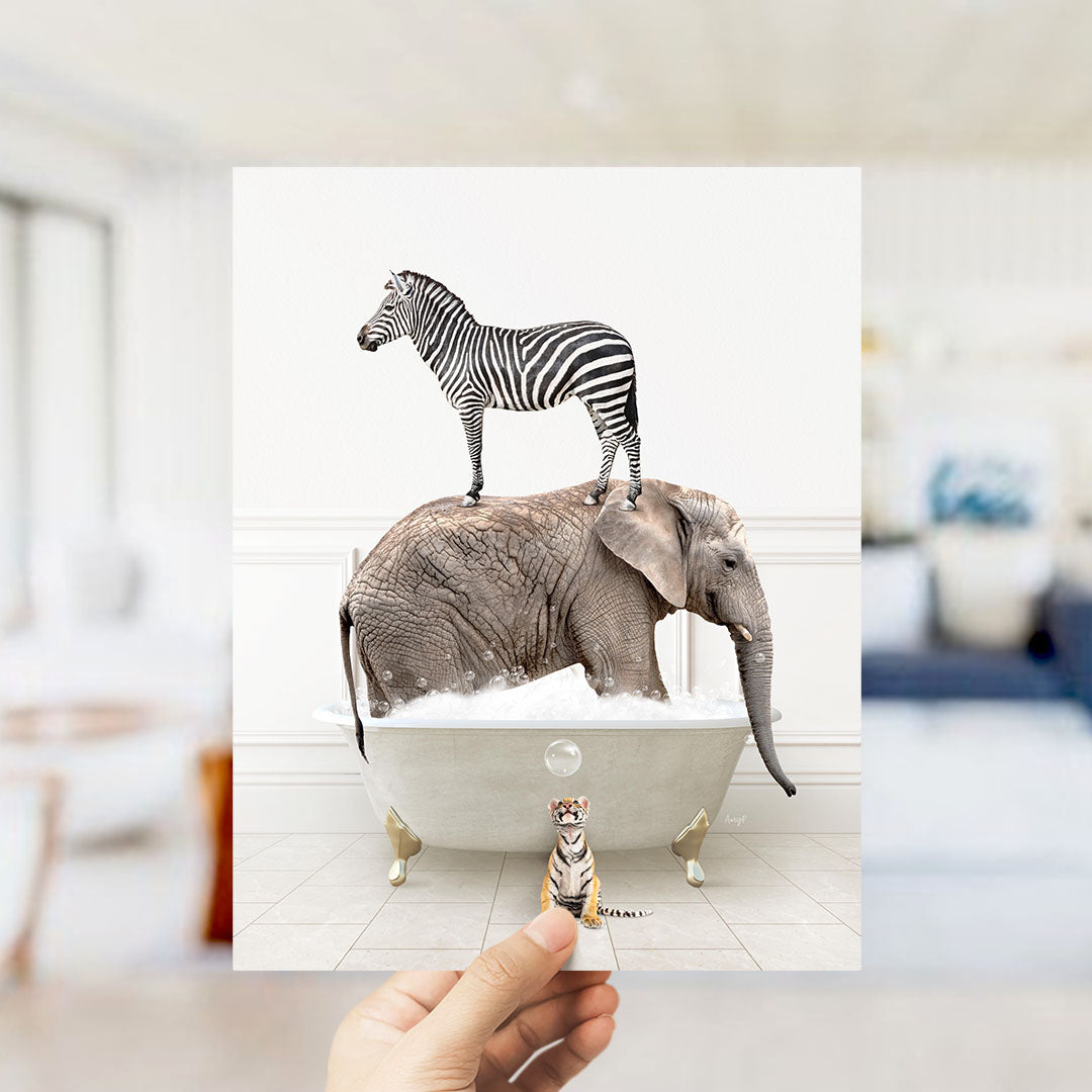 A hand holds up a collage of two images: a zebra standing on an elephant's back in a bathtub, and a small tiger figurine sitting in the tub.