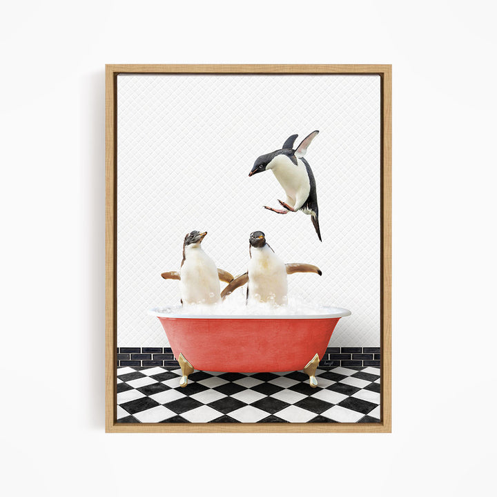 A framed image depicting two penguins standing in a red bathtub filled with water, with one penguin flying towards the other.