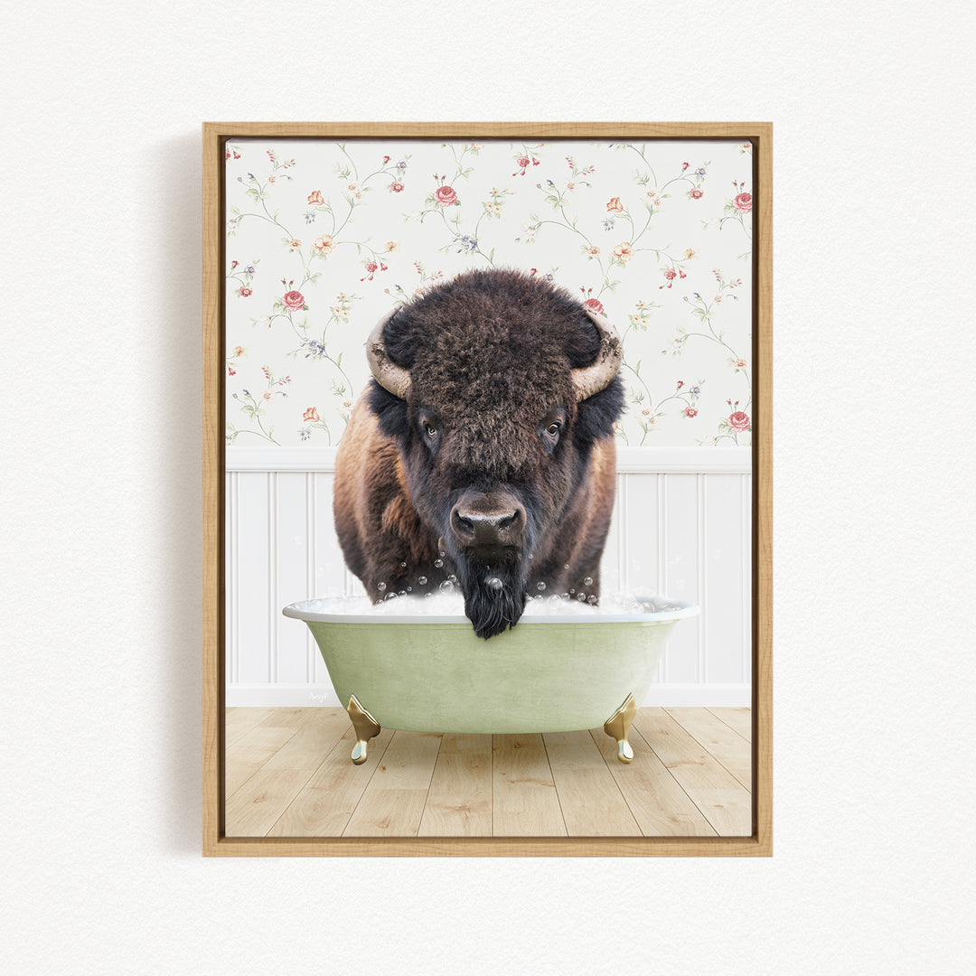 A buffalo with a long beard is sitting in a green bathtub, looking directly at the camera.