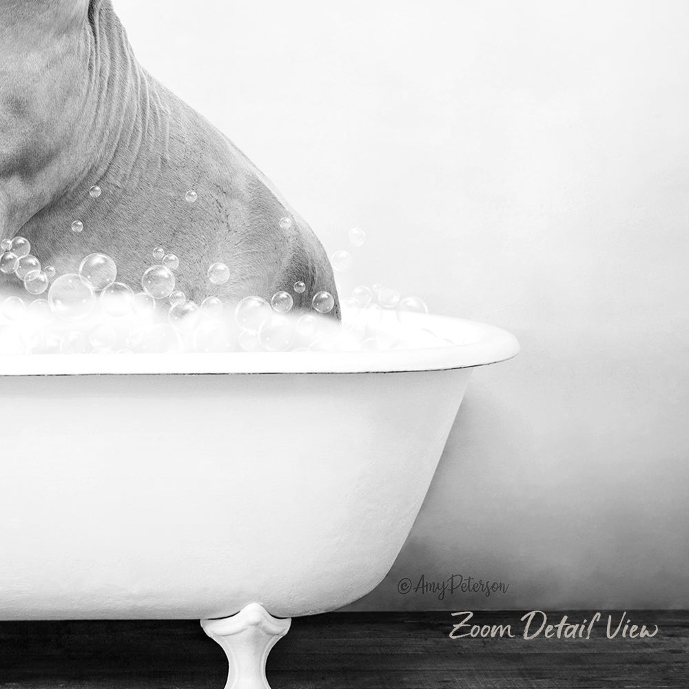 A close-up black and white image of a person's body partially submerged in a bathtub filled with bubbles.