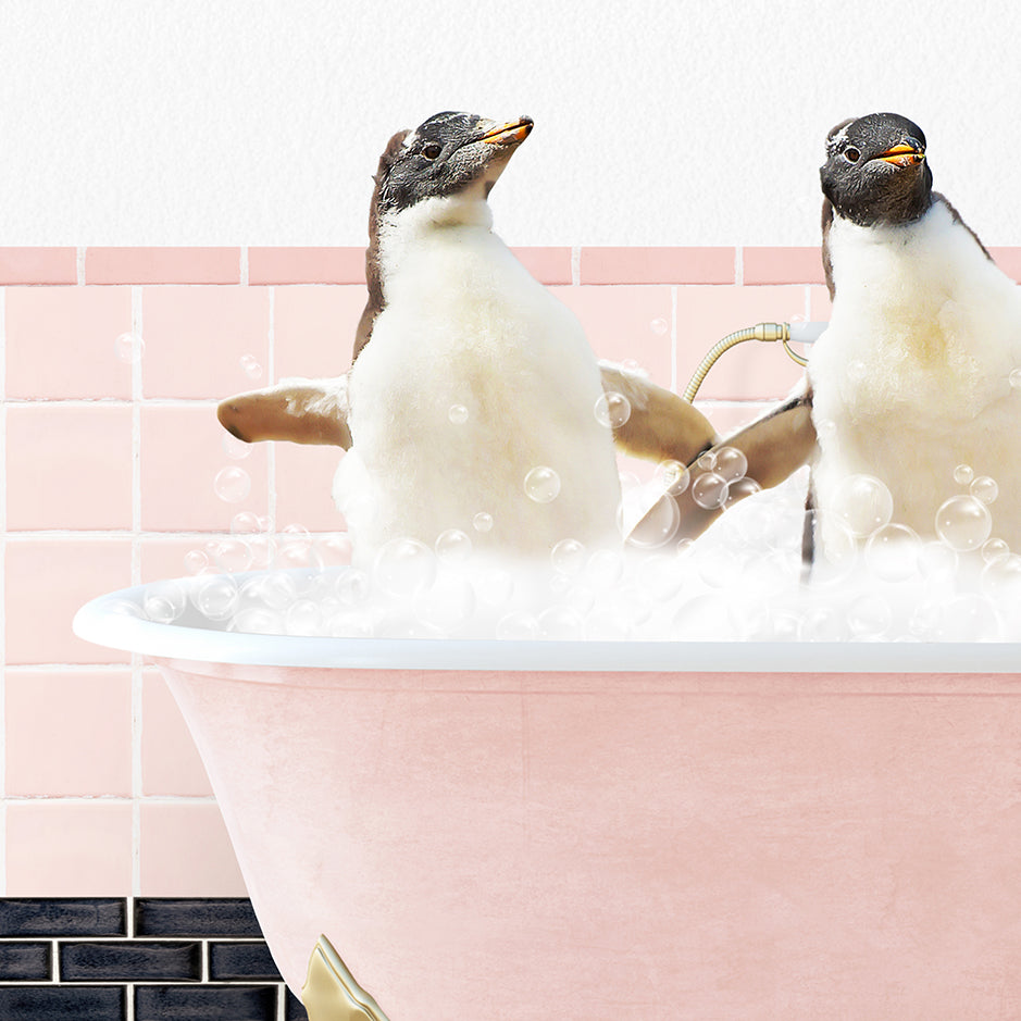 two penguins sitting in a bathtub full of bubbles