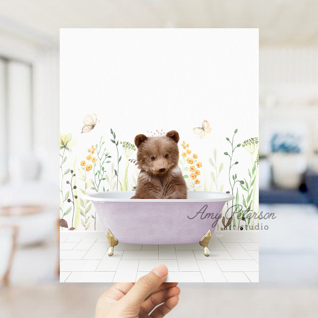 a person holding a card with a picture of a teddy bear in a bathtub