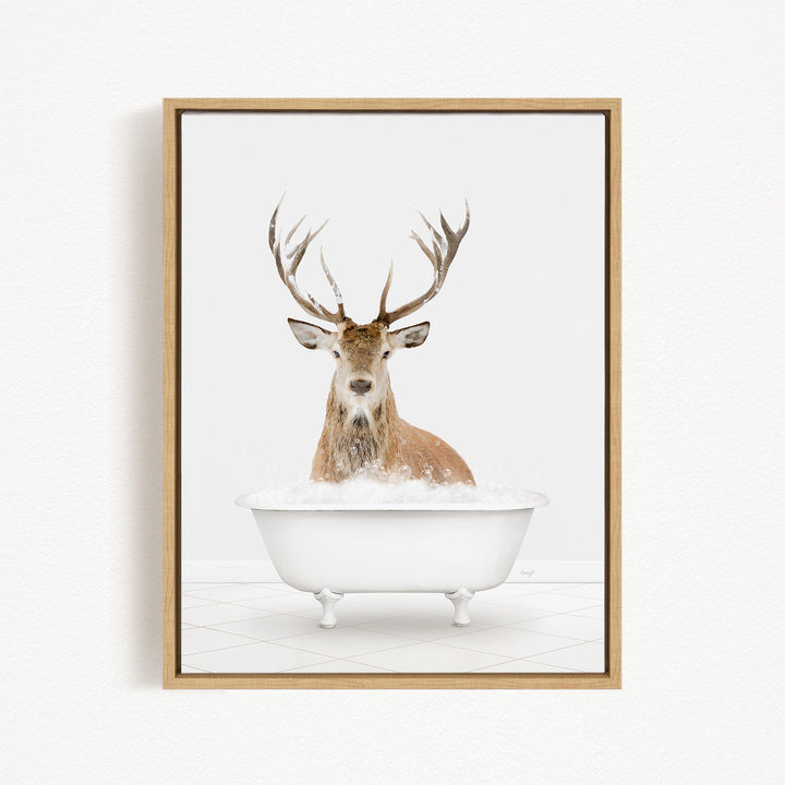 A deer with large antlers is sitting in a white bathtub filled with bubbles, creating a whimsical and playful scene.