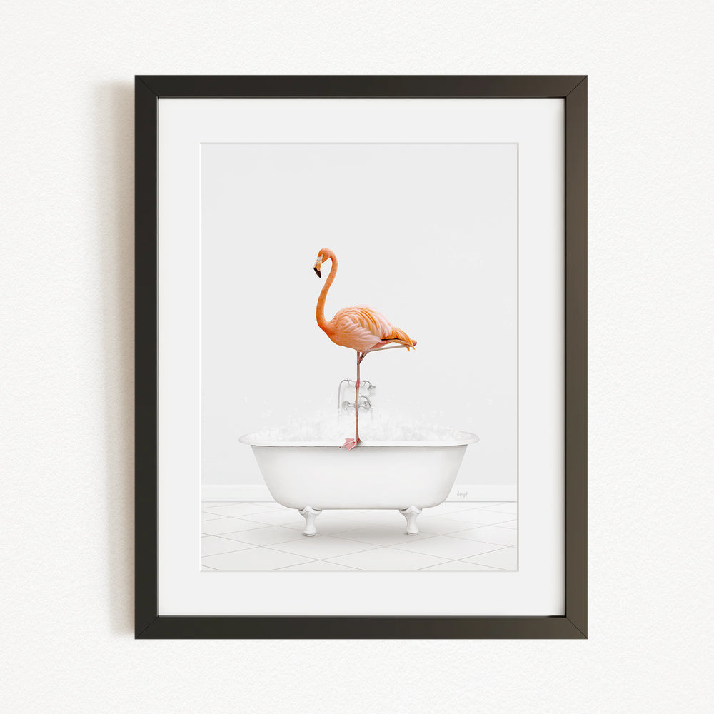 A framed image depicting a flamingo standing on a white bathtub filled with water.