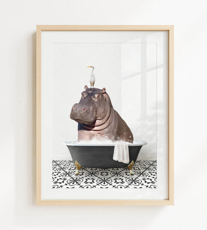 A framed image depicting a hippopotamus sitting in a bathtub, with a seagull perched on its head.