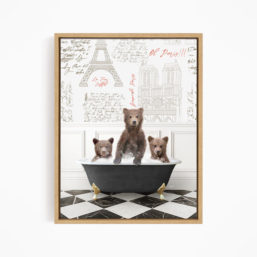 A framed image depicting three bears sitting in a bathtub, with a backdrop of the Eiffel Tower and other Parisian landmarks.