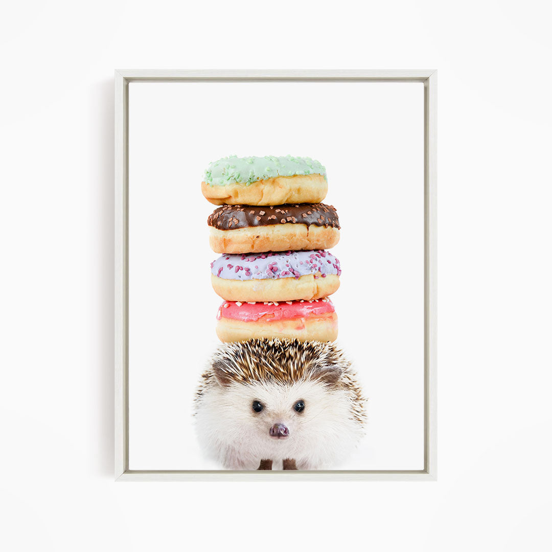 A hedgehog is sitting in front of a stack of colorful donuts, with the donuts piled on top of the hedgehog.