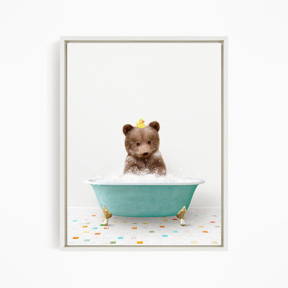 A brown bear sitting in a blue bathtub filled with bubbles, with a yellow rubber duck floating on the water.