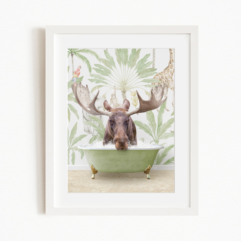 A moose with large antlers is sitting in a green bathtub, surrounded by a tropical wallpaper with palm leaves and a giraffe.