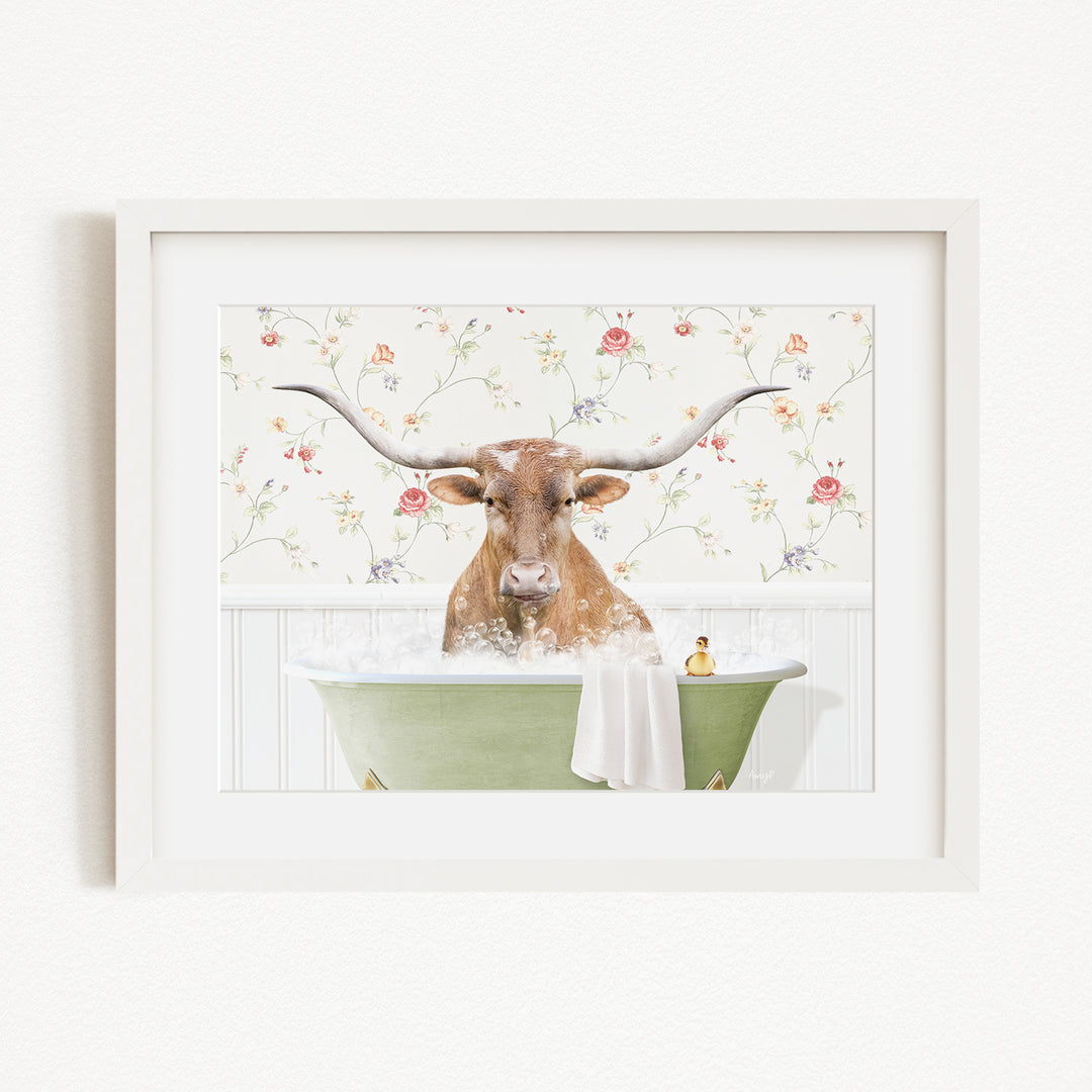 A brown cow with large horns is sitting in a green bathtub filled with water, surrounded by a floral patterned wall.