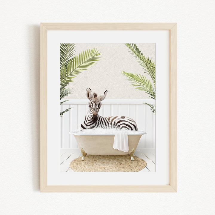 A zebra is sitting in a bathtub, surrounded by palm leaves, creating a whimsical and playful scene.
