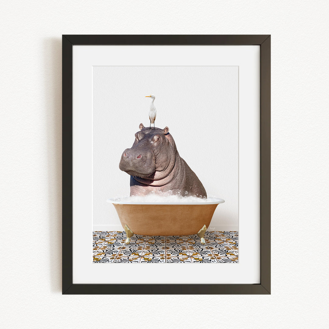 A framed image depicting a large hippopotamus sitting in a bathtub, with a seagull perched on its head.