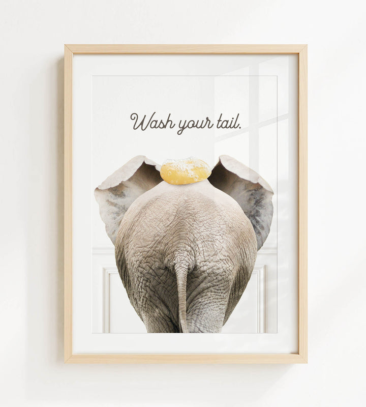 an elephant with a yellow object on its head, accompanied by the text "Wash your tail."