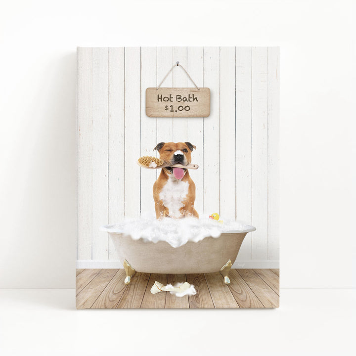 A brown and white dog sitting in a white bathtub filled with bubbles, holding a brush in its mouth, with a sign above that says "Hot Bath $1.00".