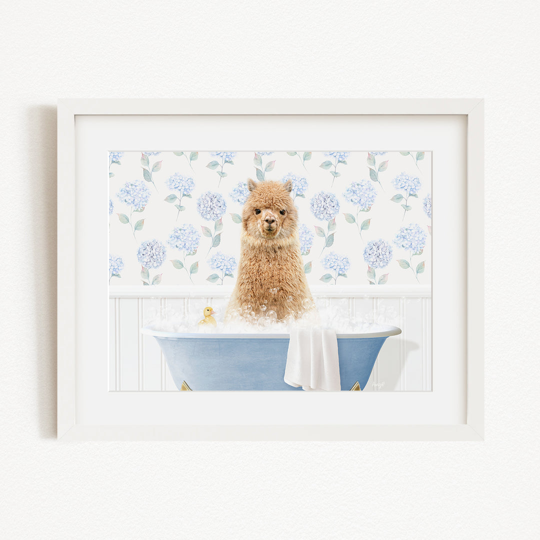 A brown alpaca sitting in a blue bathtub filled with bubbles, surrounded by a floral pattern on the wall behind it.