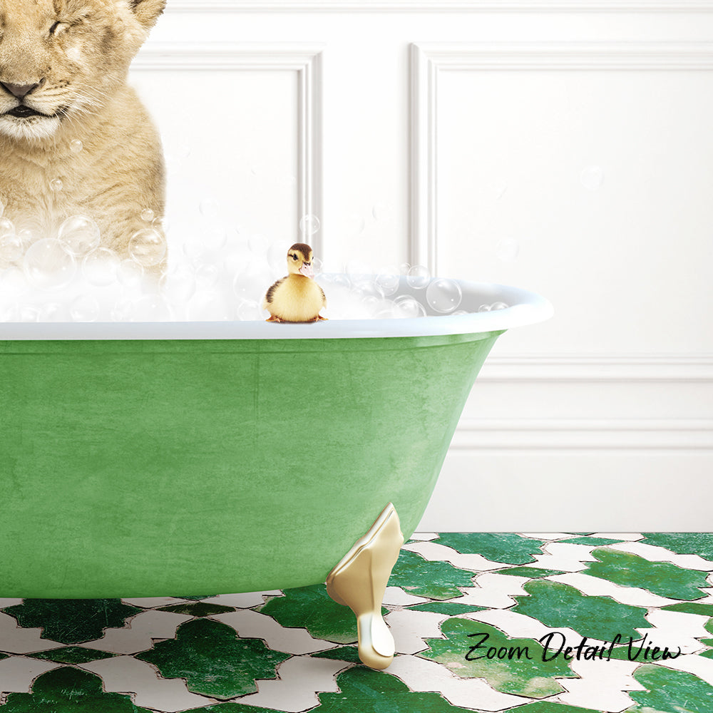 A lion cub is taking a bath in a green bathtub, with a small yellow duck sitting on the edge of the tub.