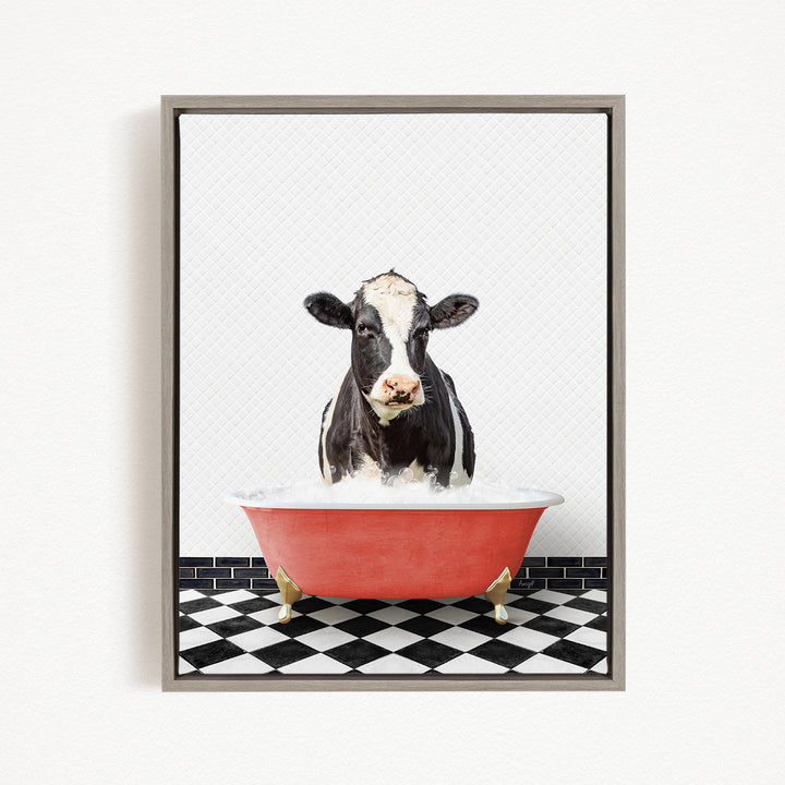A black and white cow is sitting in a red bathtub filled with water, creating a whimsical and humorous scene.
