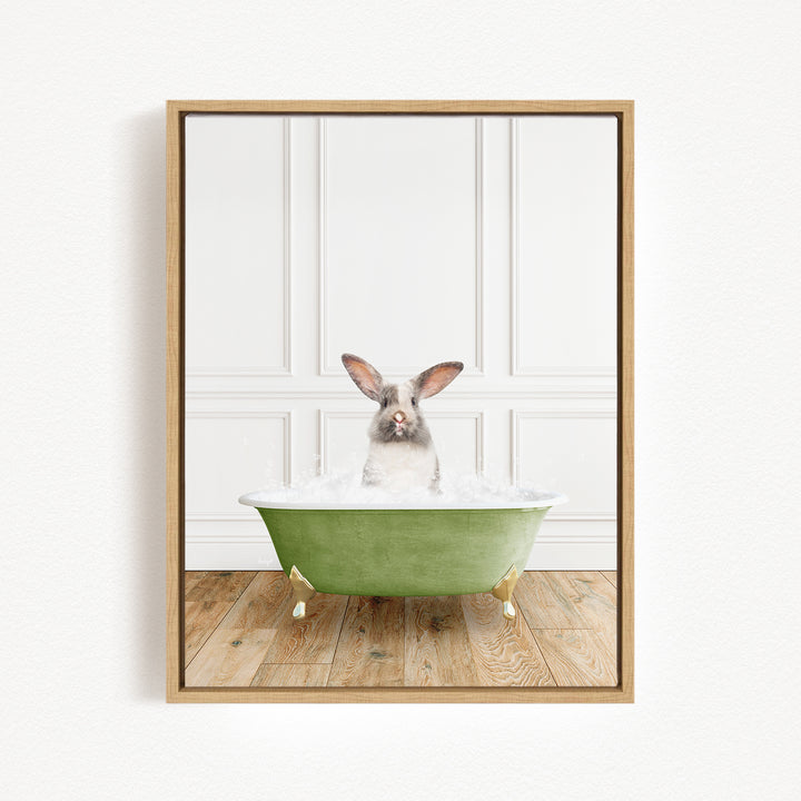 A white rabbit sitting in a green bathtub filled with water, with a wooden floor in the background.