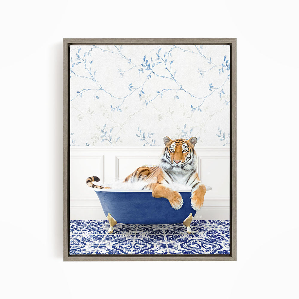 A tiger is sitting in a blue bathtub, surrounded by a patterned blue and white rug.