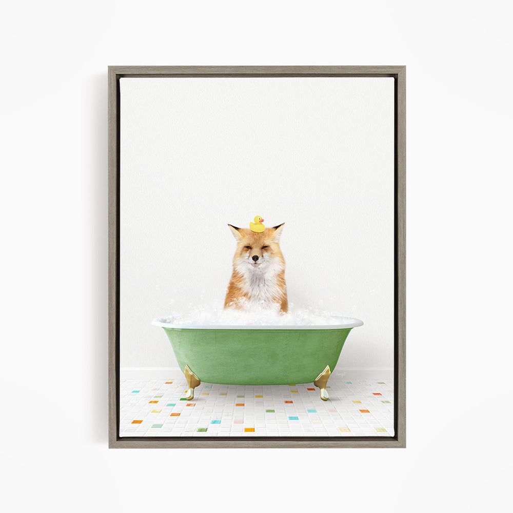 A fox is sitting in a green bathtub filled with bubbles, with a rubber duck perched on its head.