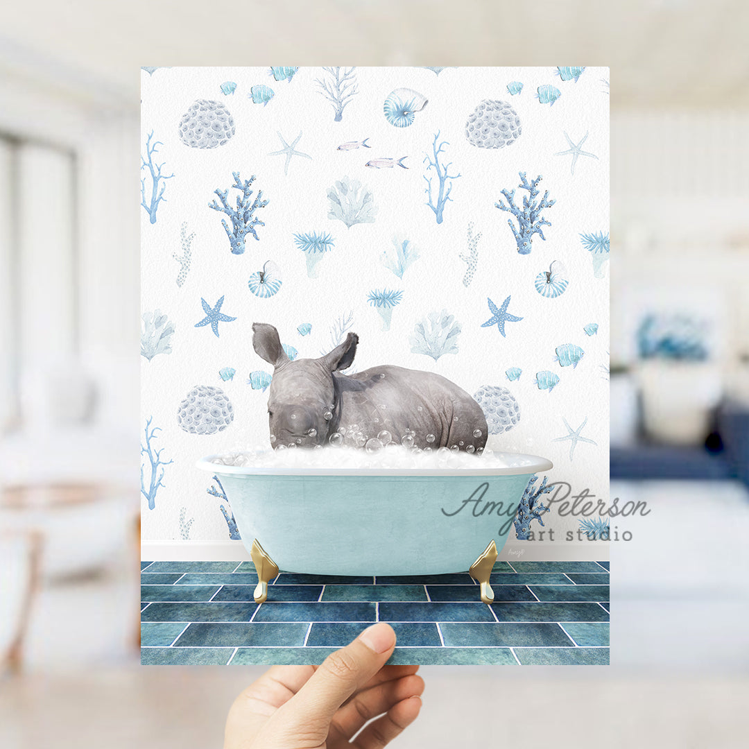 a hand holding up a card with a picture of a rhino in a bathtub