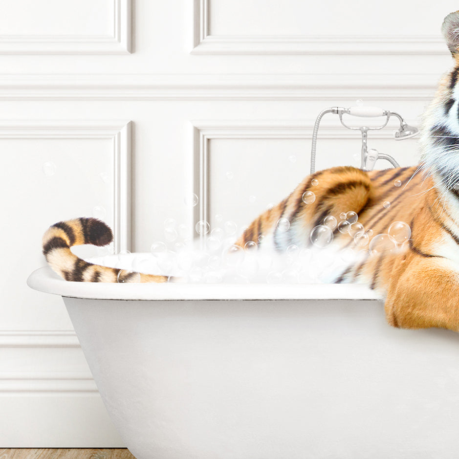 a stuffed tiger sitting in a bathtub filled with bubbles