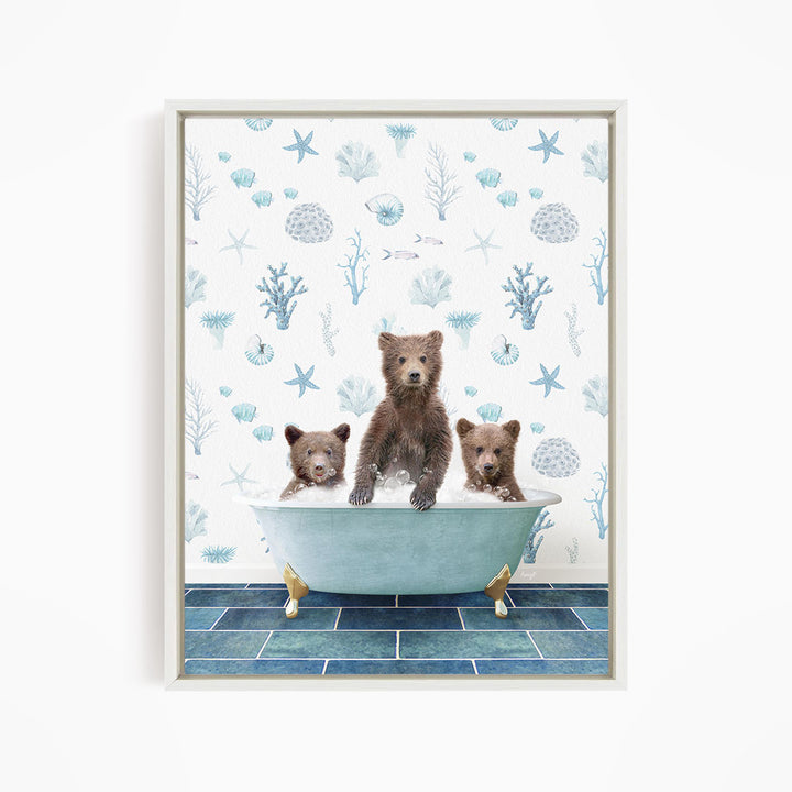 A framed print depicting three bears sitting in a bathtub filled with water, surrounded by a blue and white ocean-themed wallpaper.