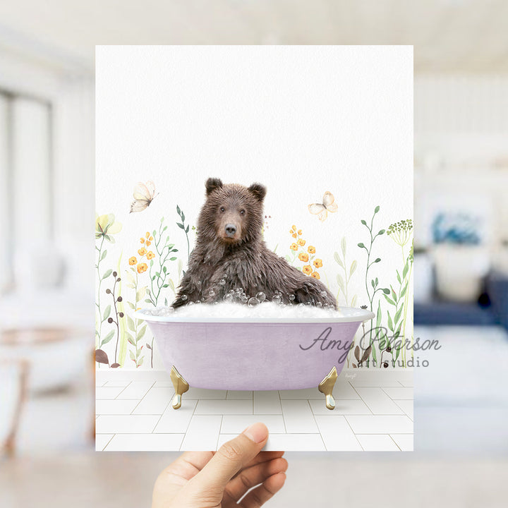 a hand holding up a card with a bear in a bathtub