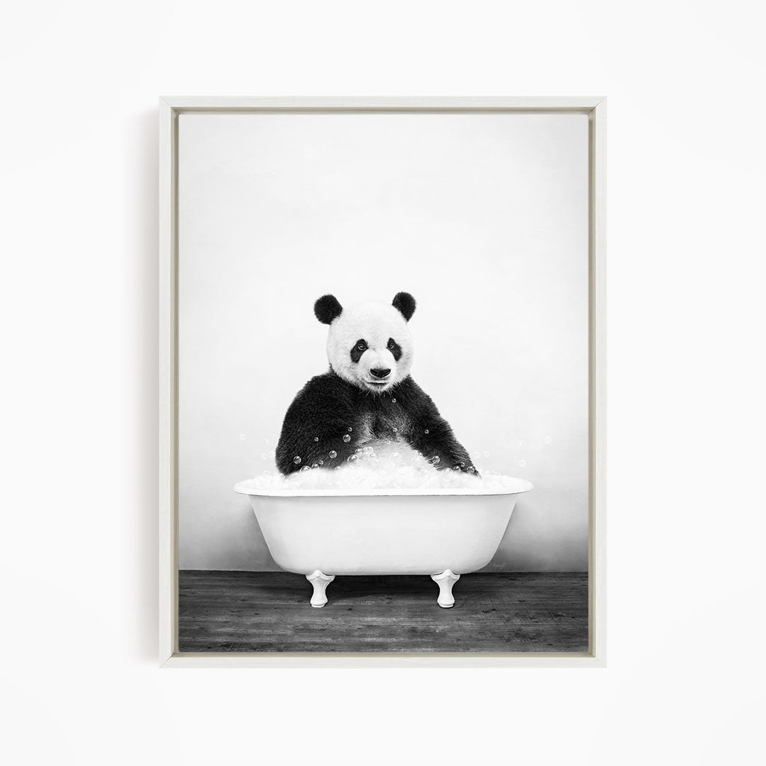 A panda bear sitting in a white bathtub filled with bubbles, creating a whimsical and playful scene.