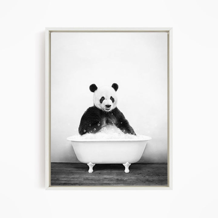 A panda bear sitting in a white bathtub filled with bubbles, creating a whimsical and playful scene.