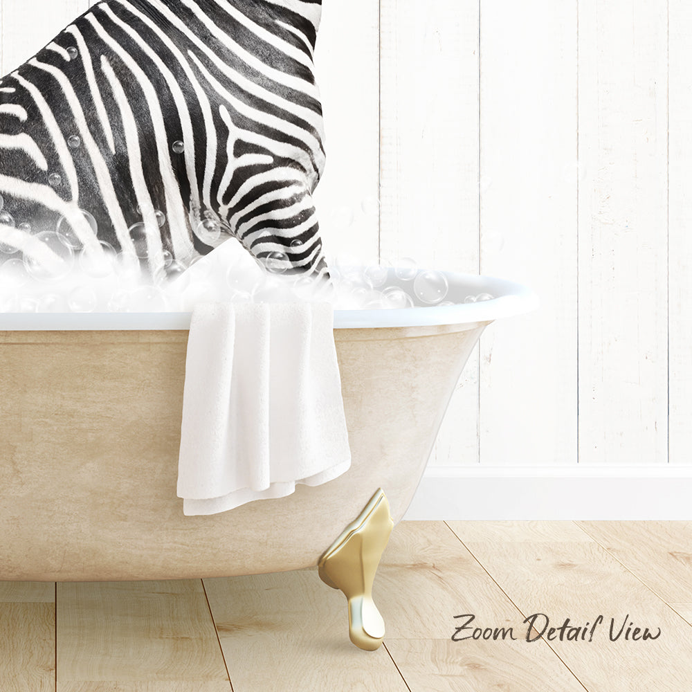 A zebra standing in a bathtub filled with bubbles, with a towel hanging on the side and a wooden floor visible beneath the tub.