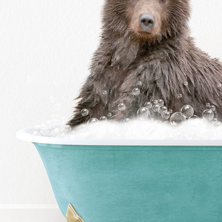 a brown bear sitting in a bathtub filled with bubbles