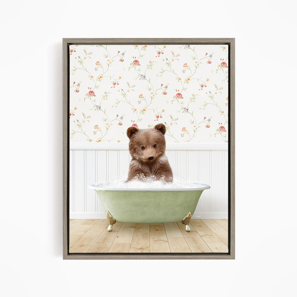 A brown bear sitting in a green bathtub filled with water, with a floral wallpaper in the background.