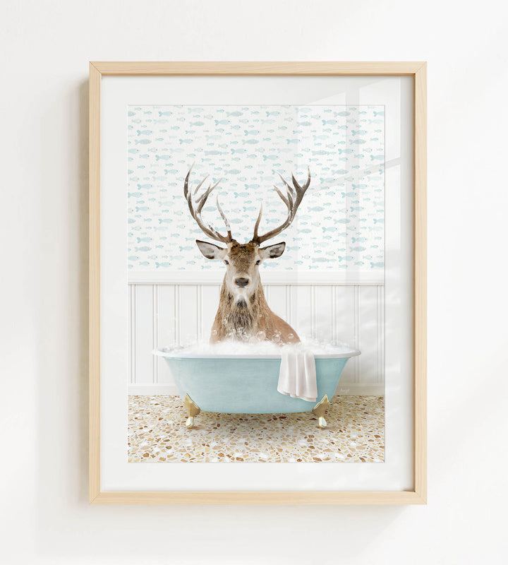 A deer with antlers is sitting in a blue bathtub filled with bubbles, surrounded by a patterned wall and a white floor.
