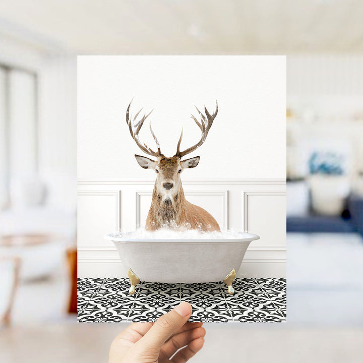 A deer with large antlers is sitting in a bathtub filled with bubbles, creating a whimsical and unexpected scene.