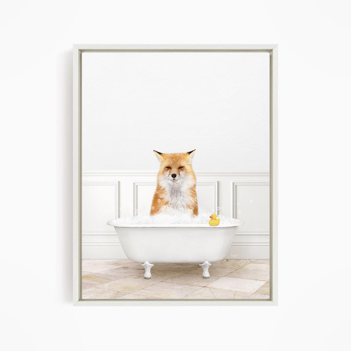 A red fox is sitting in a white bathtub filled with water, with a rubber duck floating in the water.