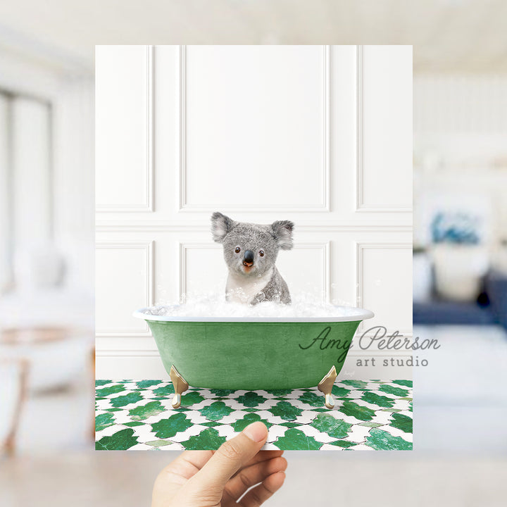 a hand holding a card with a picture of a koala in a bathtub