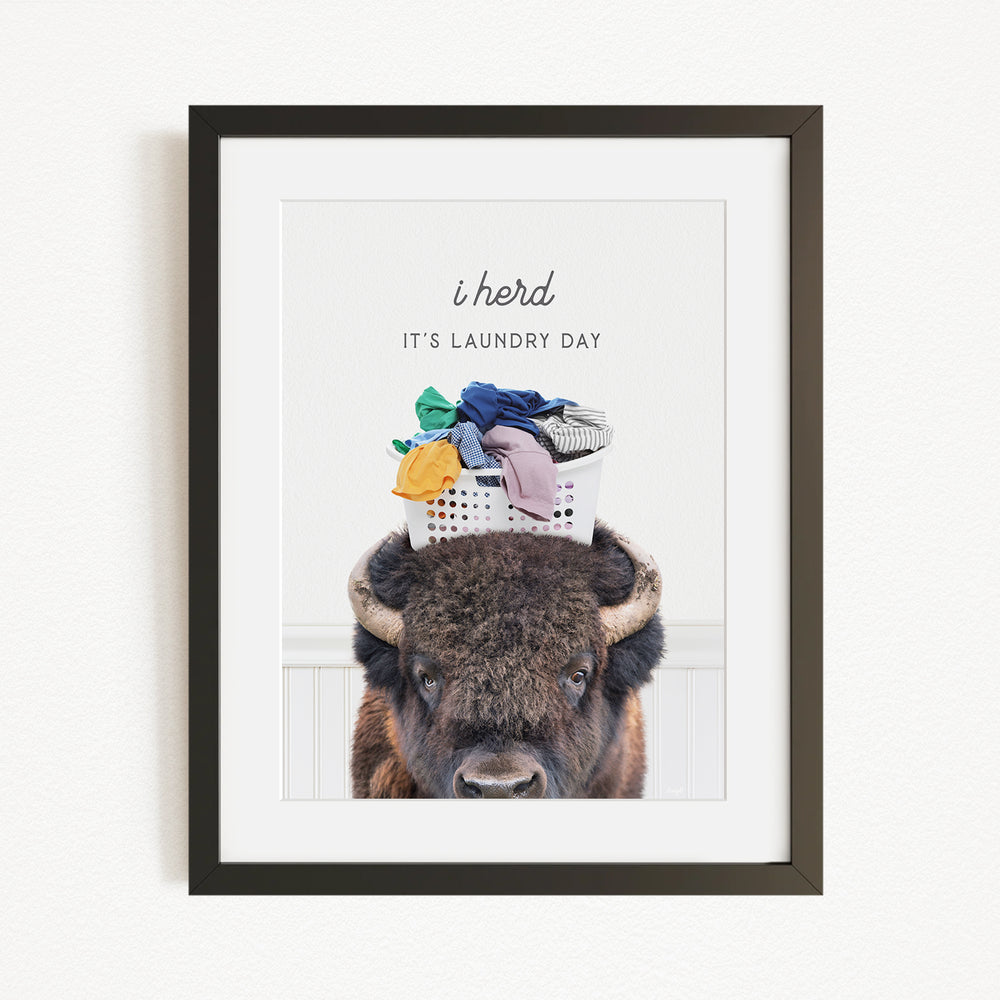 A buffalo with a laundry basket on its head, accompanied by the text "It's laundry day"