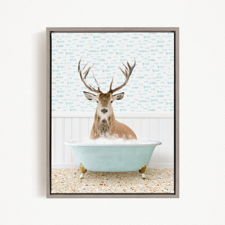 A deer with antlers is sitting in a bathtub filled with bubbles, surrounded by a pattern of fish.